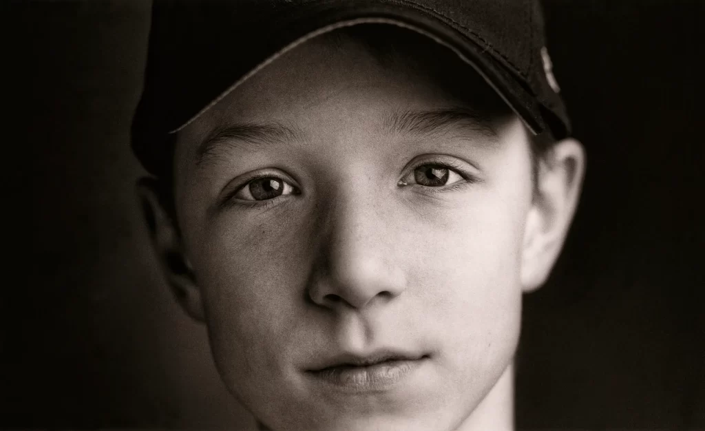 Close-up black and white portrait of a little league baseball player. Nick.