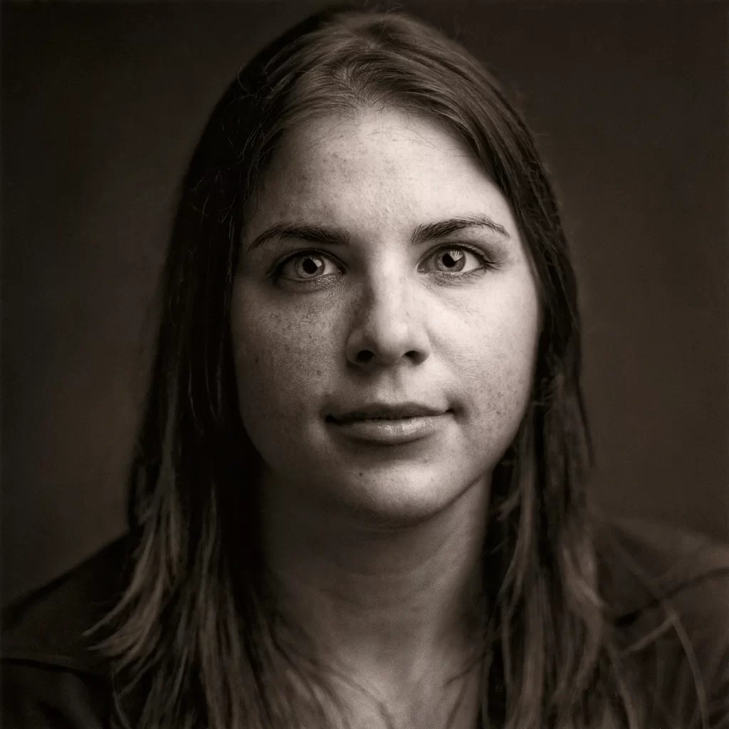 Black and white portrait of a young woman with a long straight hair.