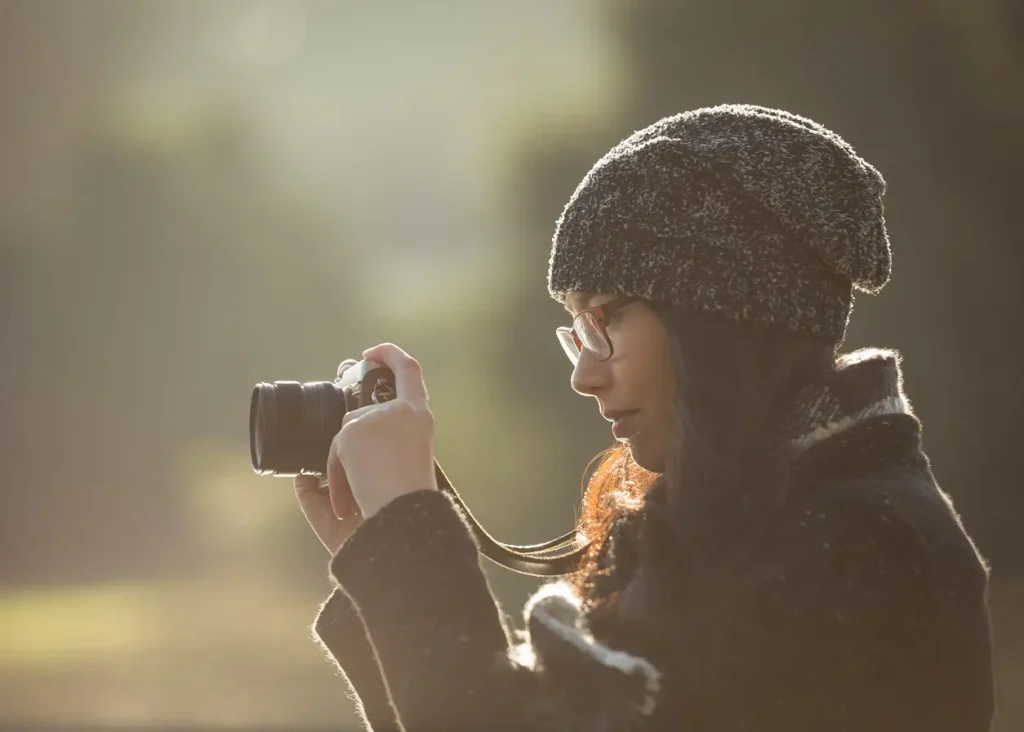 Photographer pausing to reflect and adapt their creative vision during a shoot.