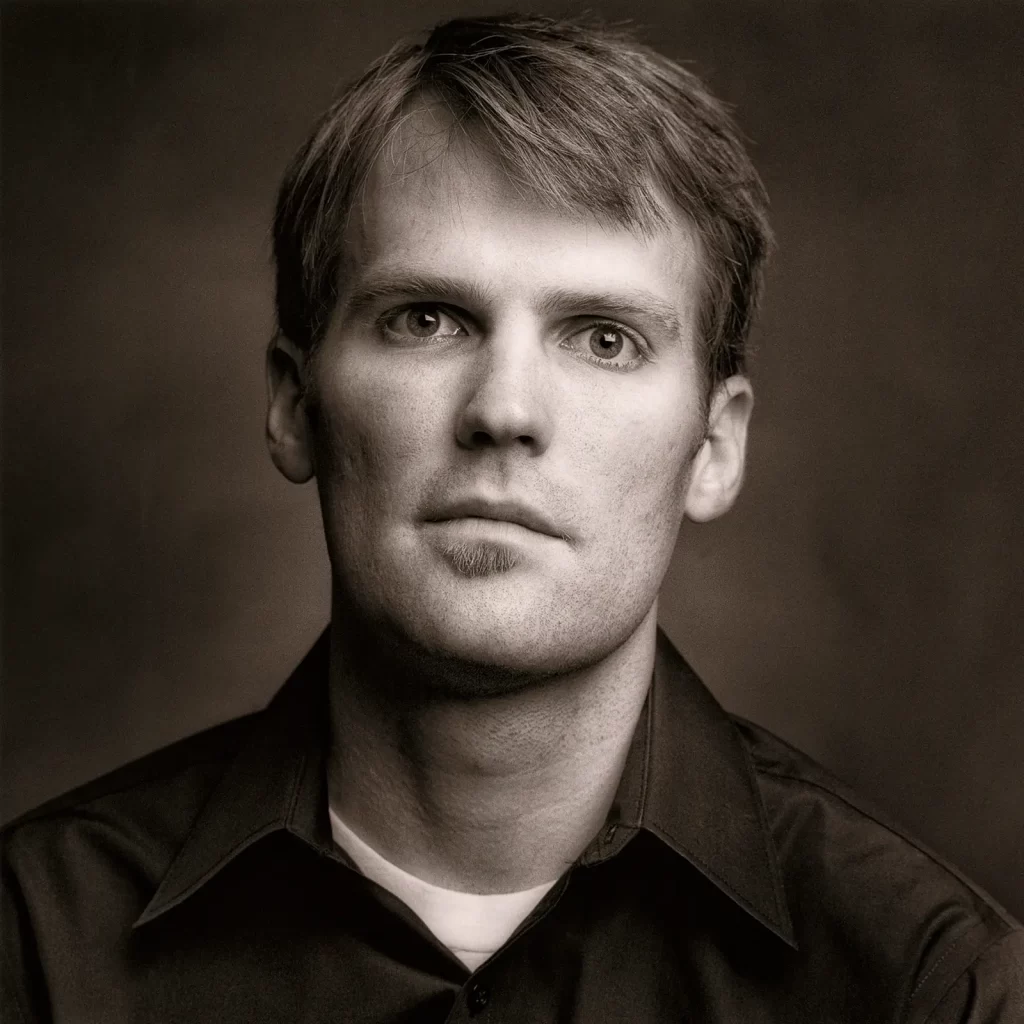 Black and white portrait of a young man with a soul patch.