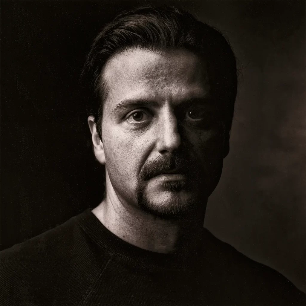 Black and white portrait of a young man with a goatee.