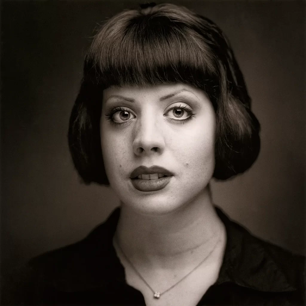 Black and white portrait of a young woman with a short bob haircut.